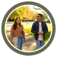 Photo of two students walking in front of Sittner Hall on a sunny day